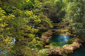 Travertine pools in the River Una at the Small Waterfalls at Martin Brod in Una-Sana Canton, Federation of Bosnia and Herzegovina. Located within the Una National Park. Early September