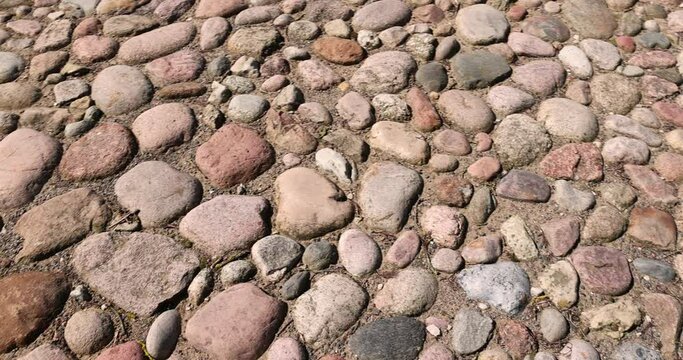 a road made of stones and cobblestones, details of a highway made of stones and cobblestones