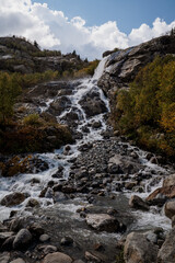 waterfall in the mountains in the autumn forest