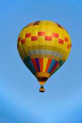 Fototapeta premium Colorful balloon over blue sky in the bright sun light.