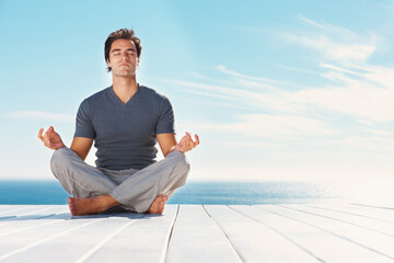 Yoga, blue sky and relax man meditate for spiritual mindset healing, chakra energy balance or...