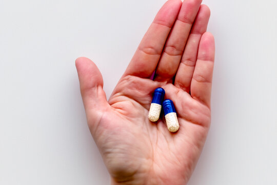 pills on the palm. medicines lie on the palm close-up. health care treatment concept
