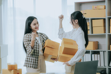 Two beautiful Asian women are happy and excited after receiving a new order from an SME customer....