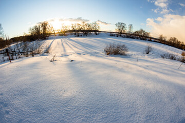 Fototapeta na wymiar Panoramic view of snow-covered nature on a sunny winter day