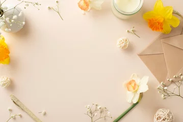 Tuinposter Extend your heartfelt spring wishes with daffodils and gypsophila. Top view image captures flowers, an envelope, aroma candle and decor on a serene beige isolated background, ready for adverts or text © ActionGP