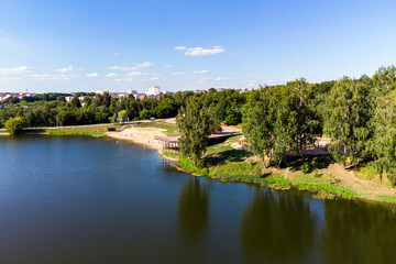 Fototapeta na wymiar Equipped city beach on a pond on the Stradalovka River in the city of Balabanovo, Russia. Aerial view