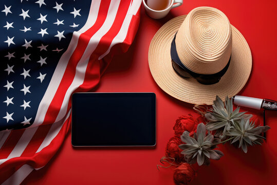 National flag, tablet, plant and straw hat on red background background. A card for the Independence Day of the USA