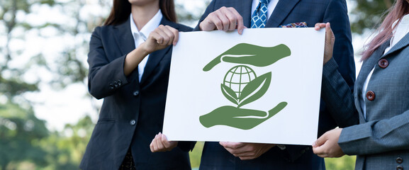 Group of business people stand united, holding eco-friendly idea and concept for environmental...