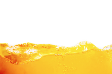 Orange juice with bubbles isolated on a white background. Close-up.