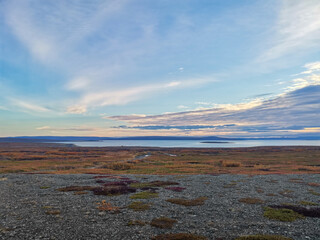 The rocky coast of the Barents Sea. Beautiful view of the rocks and the coast of the Rybachy and Sredny peninsulas, Murmansk region, Russia. The landscape is the harsh beauty of the north.