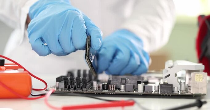 Master inserting ram into computer motherboard closeup 4k movie slow motion. A ssembly of computer equipment concept