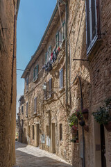 Fototapeta na wymiar old stone houses in narrow street, Volterra, Italy