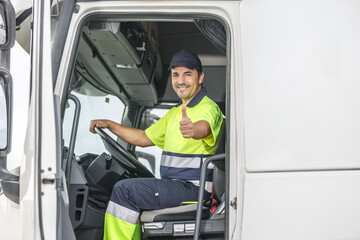 Cheerful male driver showing thumb up gesture while sitting in truck