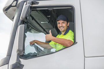 Cheerful man showing thumb up gesture while driving truck