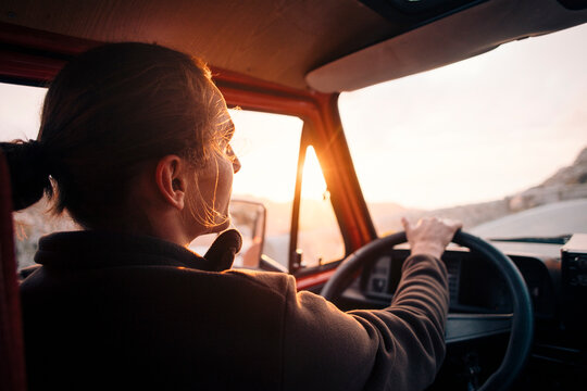 Young man driving man at sunset on vacation