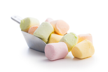 Sweet marshmallows candy in scoop isolated on white background.