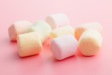 Sweet marshmallows candy on pink background.
