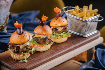 Beef Slider or mini sandwich served on wooden with french fries bucket board isolated on table top...