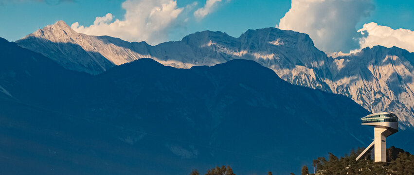 Alpine summer view with the famous Berg Isel Ski Jump Tower and the Nordkette mountains in the background near Innsbruck, Austria