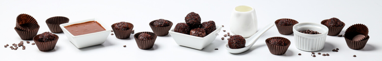 Brigadeiro and chocolate in bowls on white background