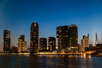 Fototapeta premium Bay of the night city of Rotterdam in the Netherlands with high-rise buildings.