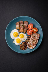 Delicious nutritious breakfast of fried quail eggs, bacon, legumes and cherry tomatoes