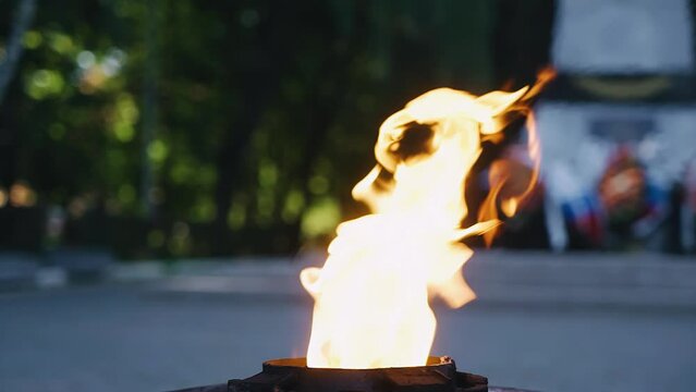 Close-up of the burning flame of the eternal flame on the monument. Shooting flames in slow motion