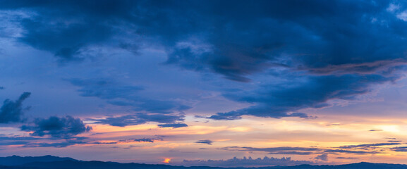 Explore the romantic panorama of an evening sky, where the sun sets in a glow of magenta and the...