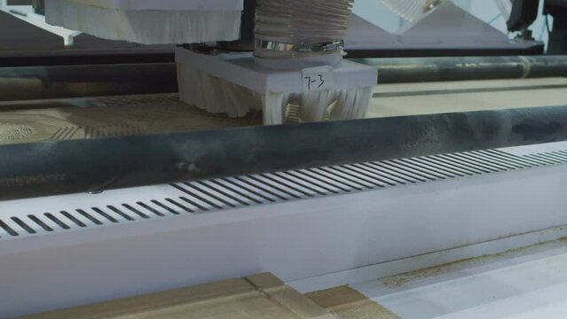 Woodworking machine produces a part for furniture production. Closeup