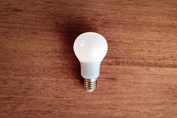 LED light bulb on wooden table.Energy saving concept.