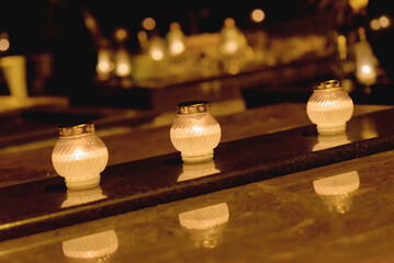 Candles Burning at Night.White Candles Burning in the Dark with lights glow.Focus on candles in...