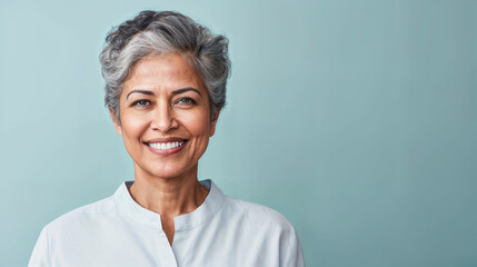 Confident mature woman with gray hair smiling. - Powered by Adobe