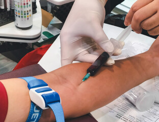 A nurse is using a syringe to draw blood from a patient. To be used to detect germs and modern medical treatments