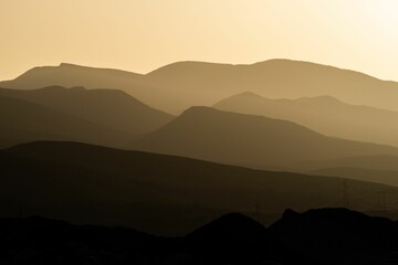 Scenic view of majestic mountains illuminated by a golden sunset