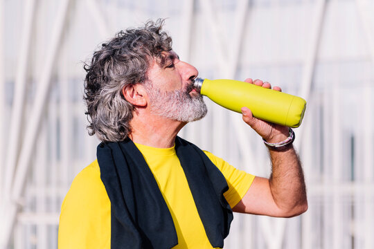 senior sports man drinking water during training, concept of healthy and active lifestyle in middle age