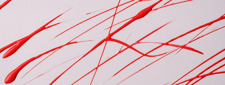 Thin red lines and splashes drawn on white background. Abstract art backdrop with brush decorative stroke.