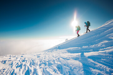 winter activity. Two women walking in snowshoes in the snow, winter hiking, two people in the...
