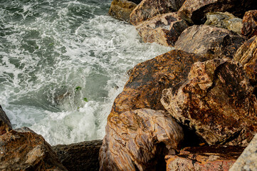waves crashing on rocks at the sea