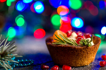 Christmas nut tartlets. Delicious, beautiful cupcakes are decorated with Christmas garlands and Christmas tree branches. Selective focus