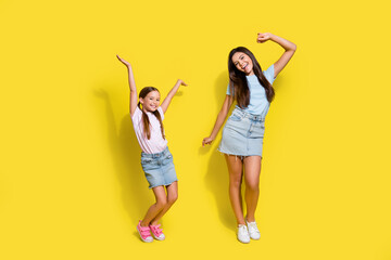 Photo of two best buddies girls dance in school party have fun isolated over vivid color background