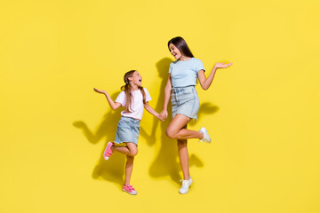 Fototapeta na wymiar Photo of two girls older younger sisters enjoy free time together isolated over bright color background
