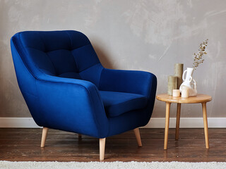 furniture, interior, home design. modern blue fabric armchair with wooden legs, side view.