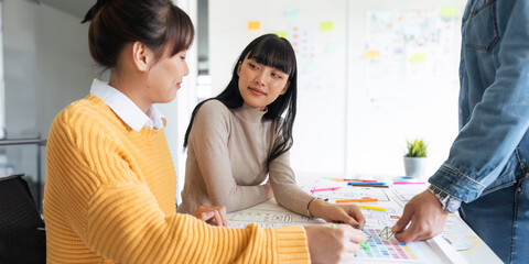 Ux developer and ui designer use augmented reality brainstorming about mobile app interface wireframe design on desk at modern office. creative digital development agency