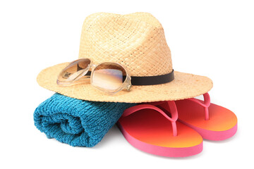Straw hat, towel, sunglasses and flip flops isolated on white. Beach objects