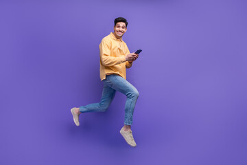Fototapeta na wymiar Full body photo of nice young male instagram twitter facebook telegram wear trendy yellow outfit isolated on violet color background