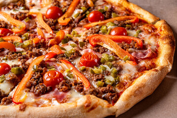 Pizza with Mozzarella cheese, Bolognese sauce, minced meat, pepper, tomato, bacon and vegetables