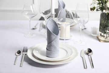 Beautiful table setting with silverware and fabric napkins