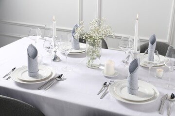 Beautiful table setting with floral decor indoors
