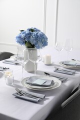 Beautiful table setting with floral decor indoors