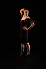 Fototapeta premium brunette woman posing in black studio